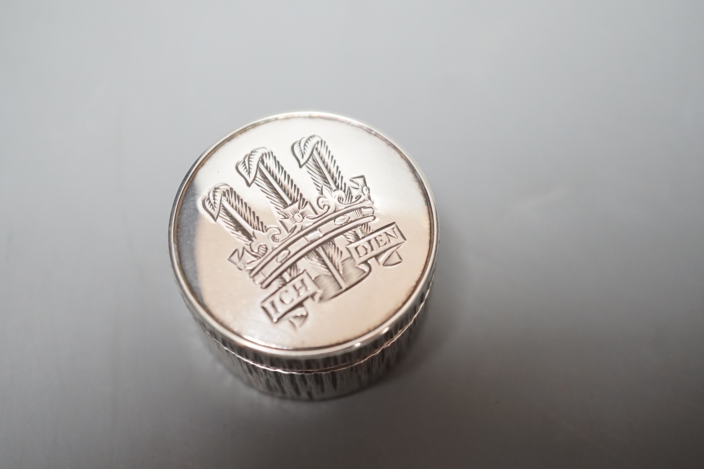 Adrian Gerald Benney- A modern textured silver pill box, engraved with the Prince of Wales feathers, London, 1997